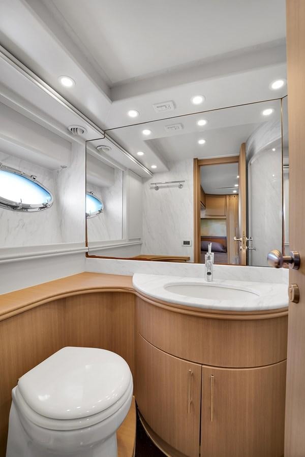 a bathroom with a toilet and a sink aboard PERSHING 88/07 Yacht for Sale