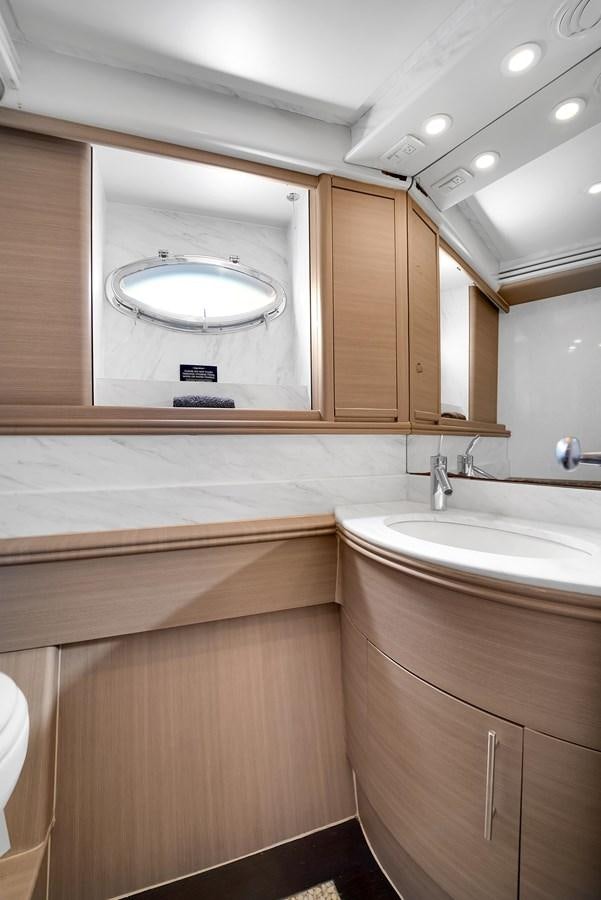 a bathroom with a large mirror aboard PERSHING 88/07 Yacht for Sale