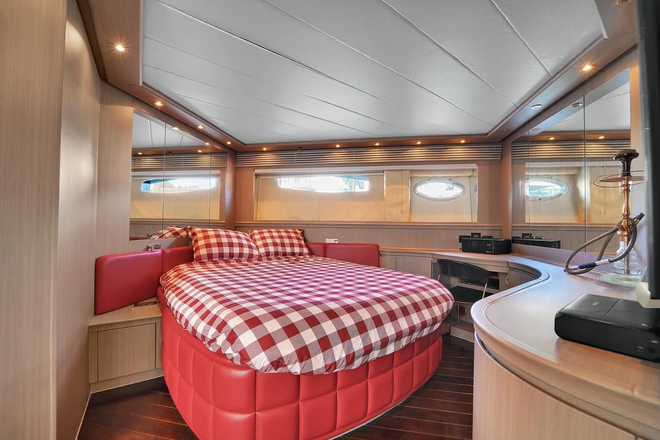 a room with a bed and a desk aboard PERSHING 88/07 Yacht for Sale