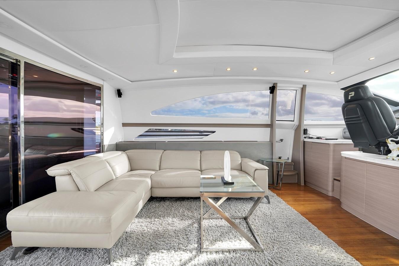 a living room with a large window aboard PERSHING 88/07 Yacht for Sale