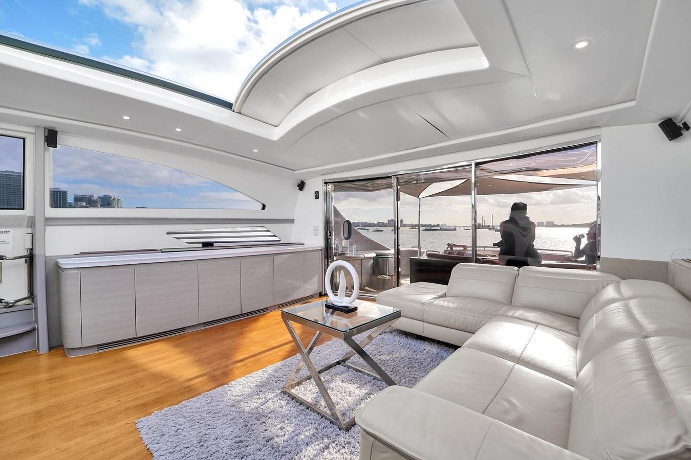 a living room with a large window aboard PERSHING 88/07 Yacht for Sale