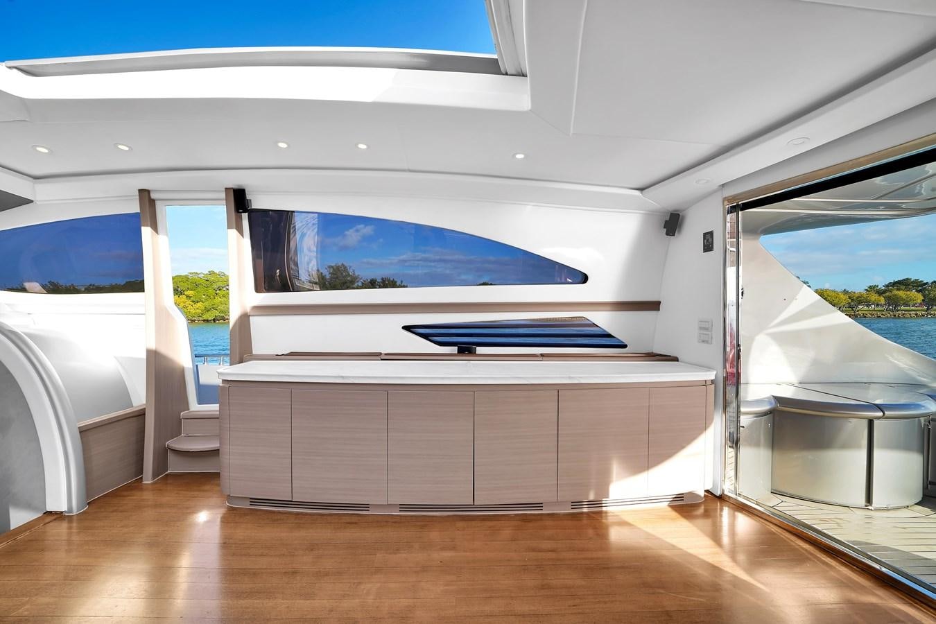 a room with a large window and a wood floor aboard PERSHING 88/07 Yacht for Sale