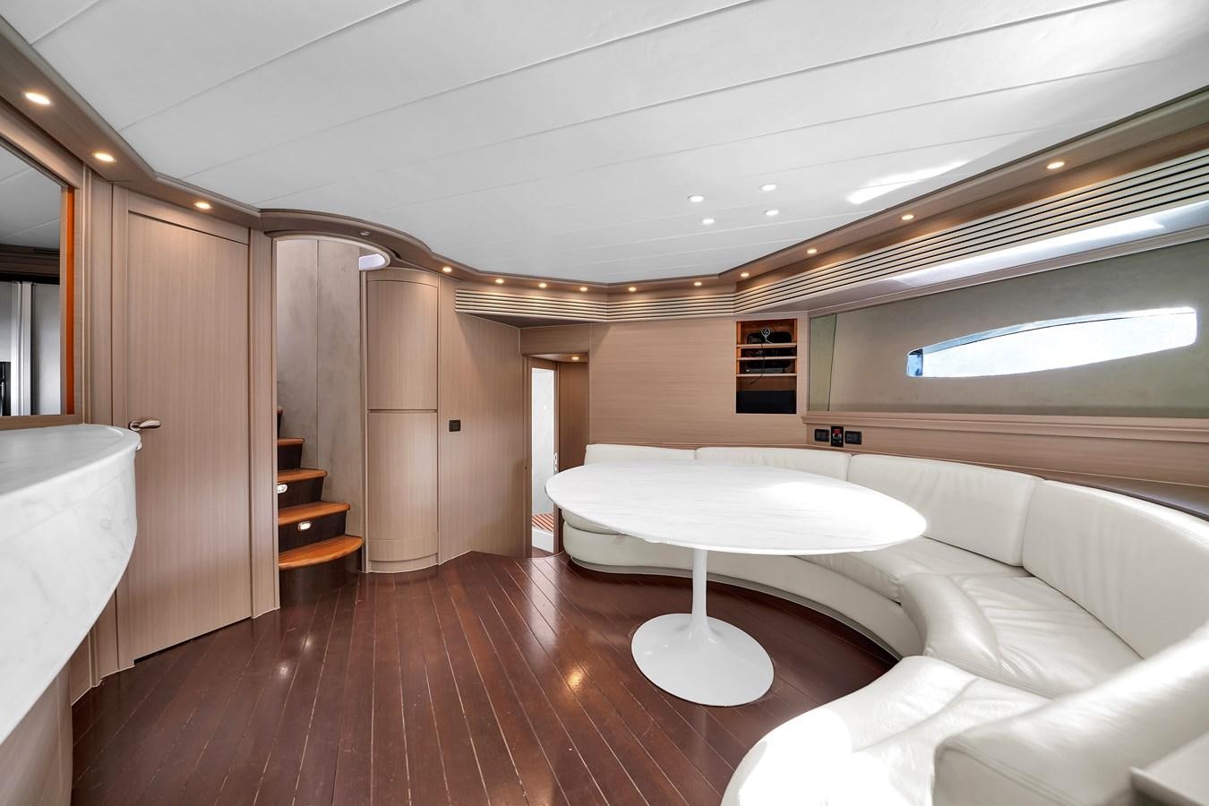 a room with a large bed and a table aboard PERSHING 88/07 Yacht for Sale
