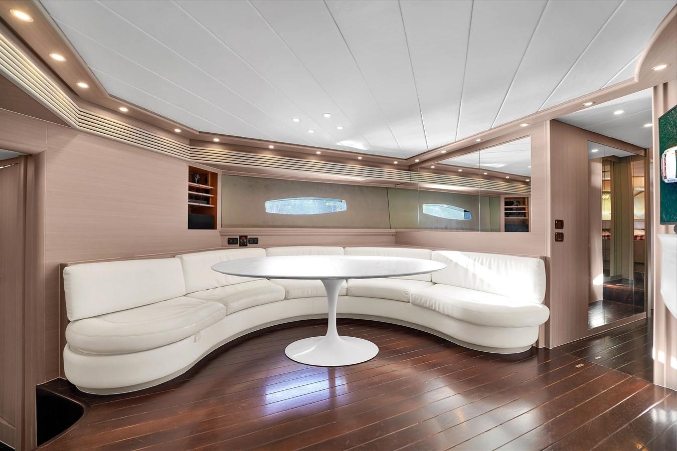 a room with a couch and a table aboard PERSHING 88/07 Yacht for Sale