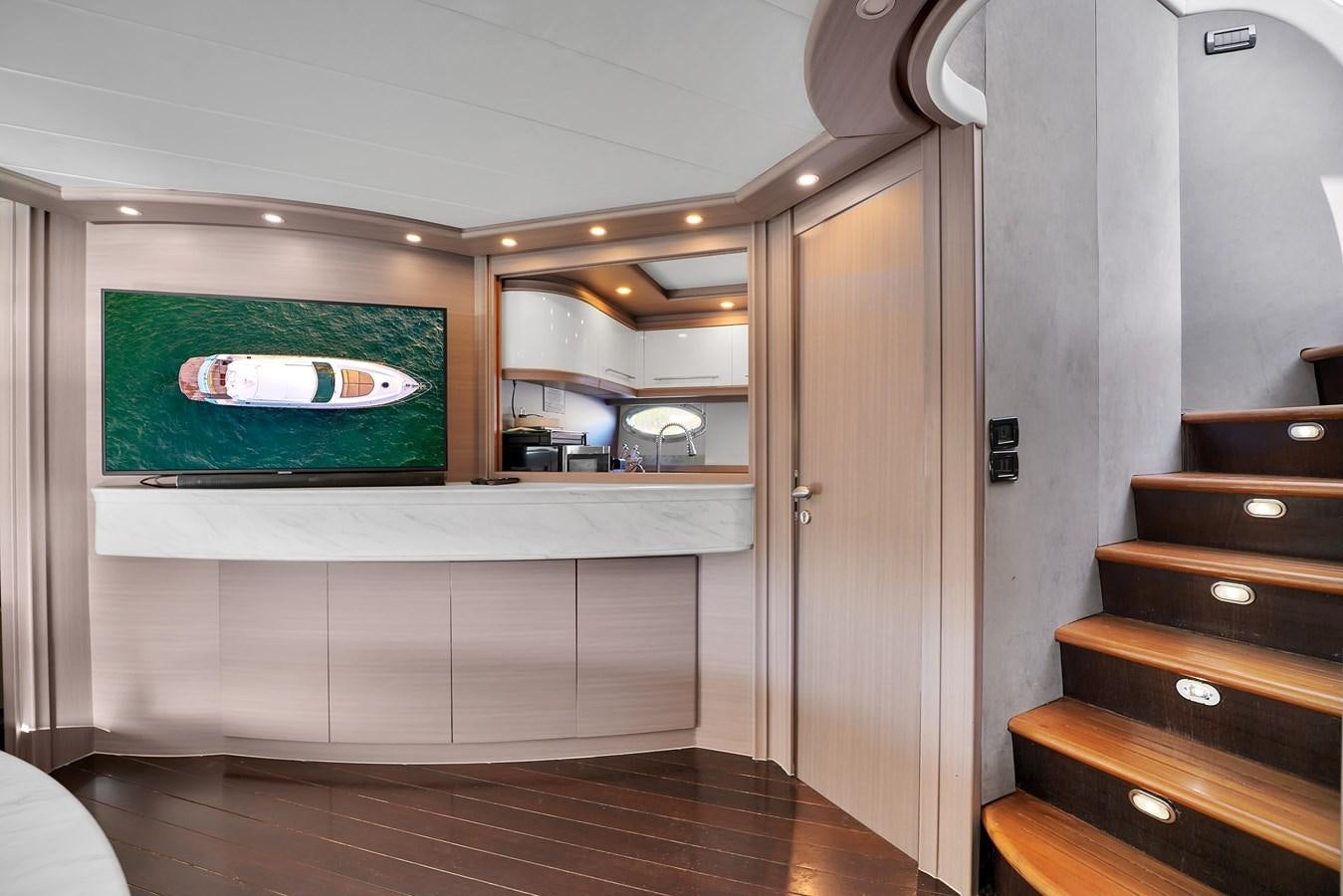 a room with a television and a dresser aboard PERSHING 88/07 Yacht for Sale