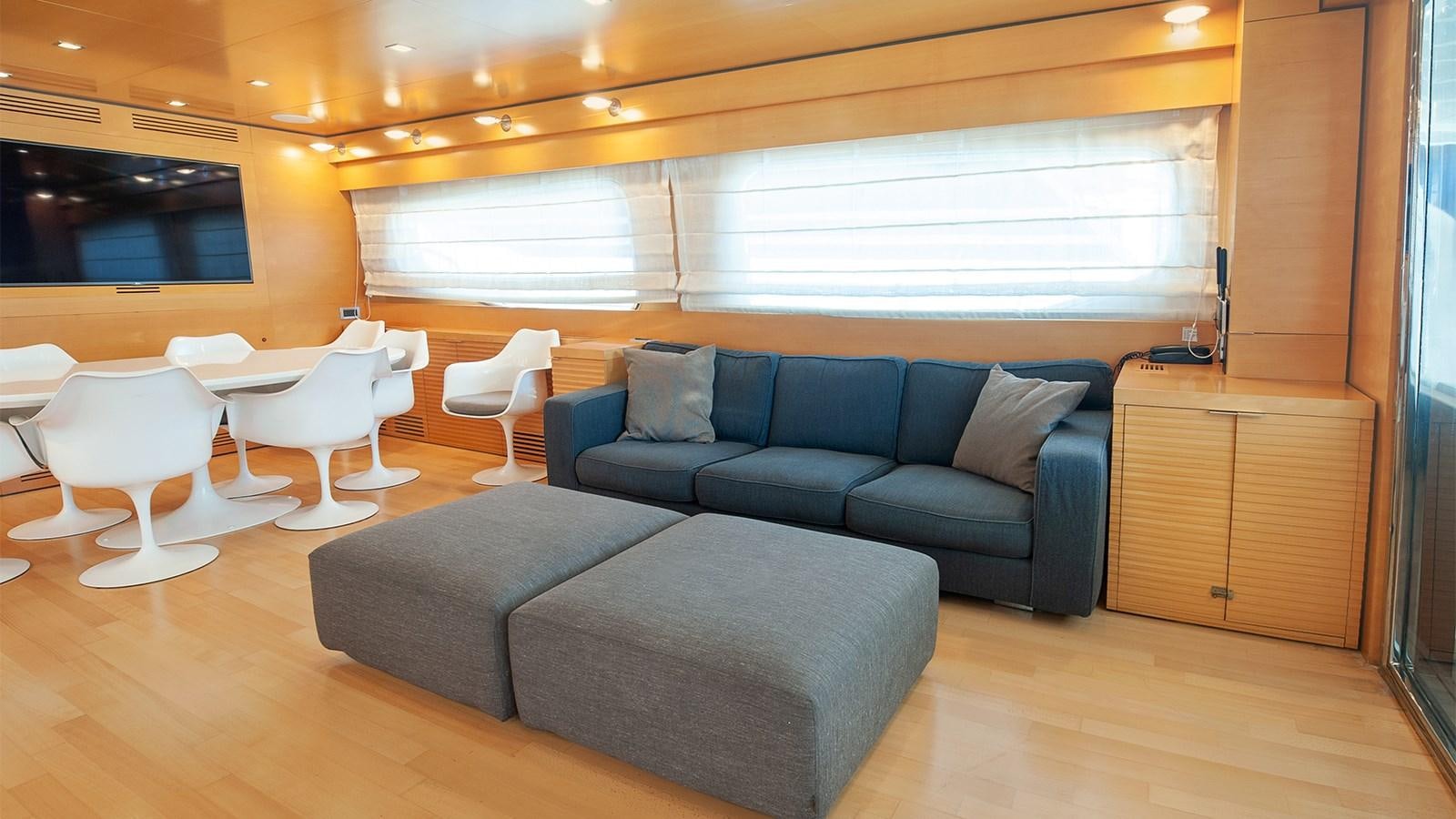 a living room with a couch and a table aboard AMYMONE Yacht for Sale