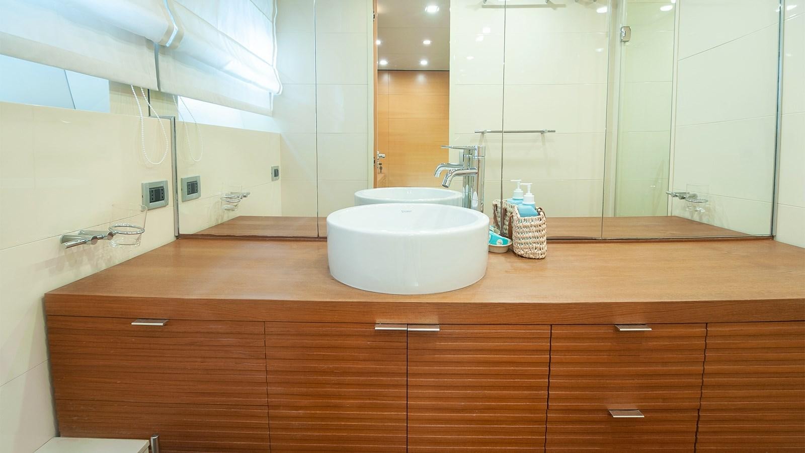 a bathroom with a sink and a mirror aboard AMYMONE Yacht for Sale