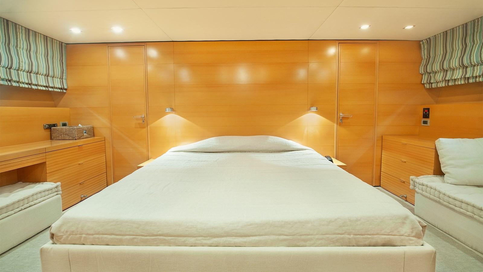 a room with a bed and a wood wall aboard AMYMONE Yacht for Sale