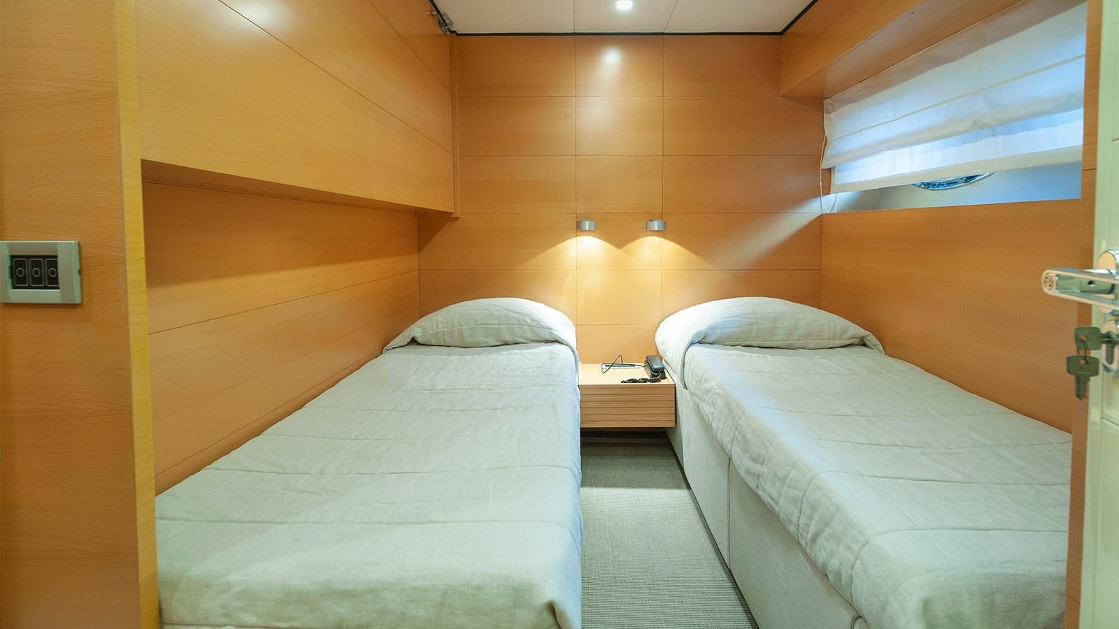 a room with beds and a door aboard AMYMONE Yacht for Sale
