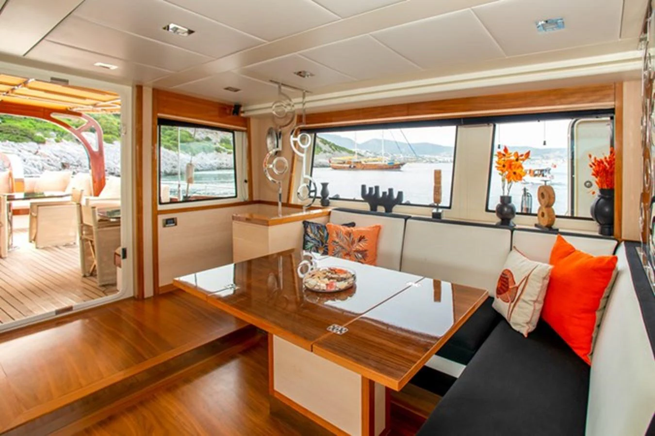 a living room with a wood table aboard VAY Yacht for Charter