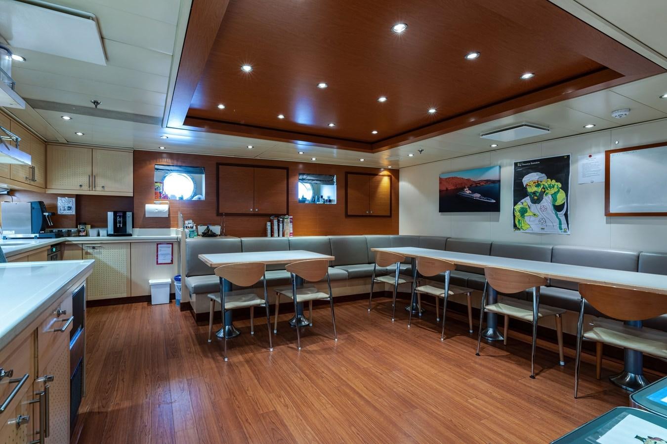 a room with tables and chairs aboard KOGO Yacht for Sale