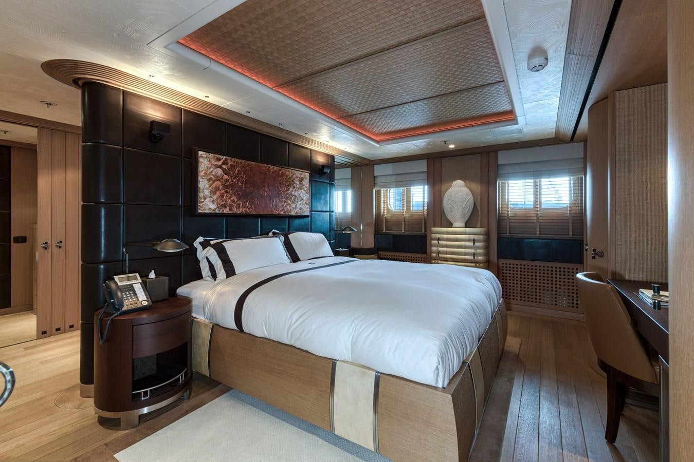 a bedroom with a bed and a desk aboard KOGO Yacht for Sale