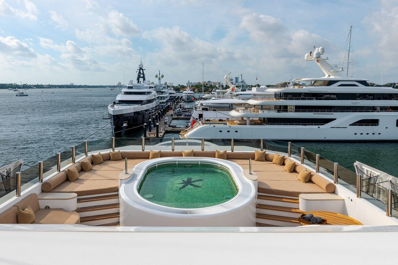 a deck with a large ship in the water aboard KOGO Yacht for Sale