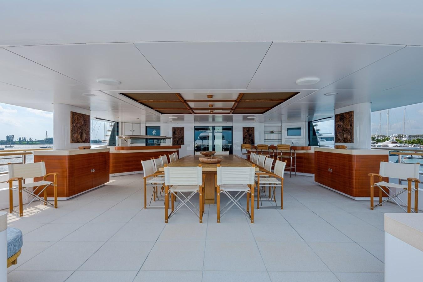 a room with tables and chairs aboard KOGO Yacht for Sale