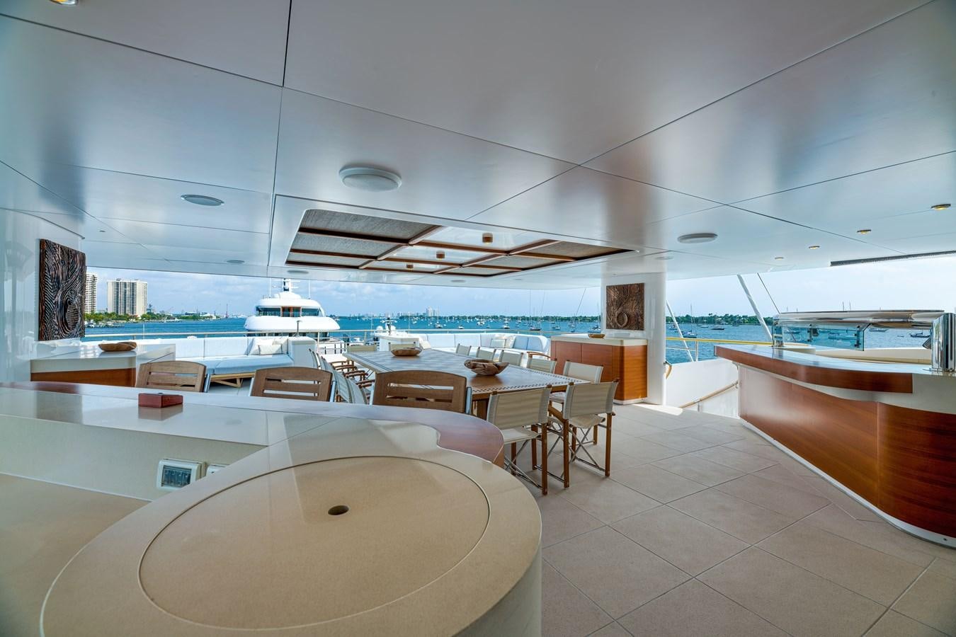 a room with tables and chairs aboard KOGO Yacht for Sale