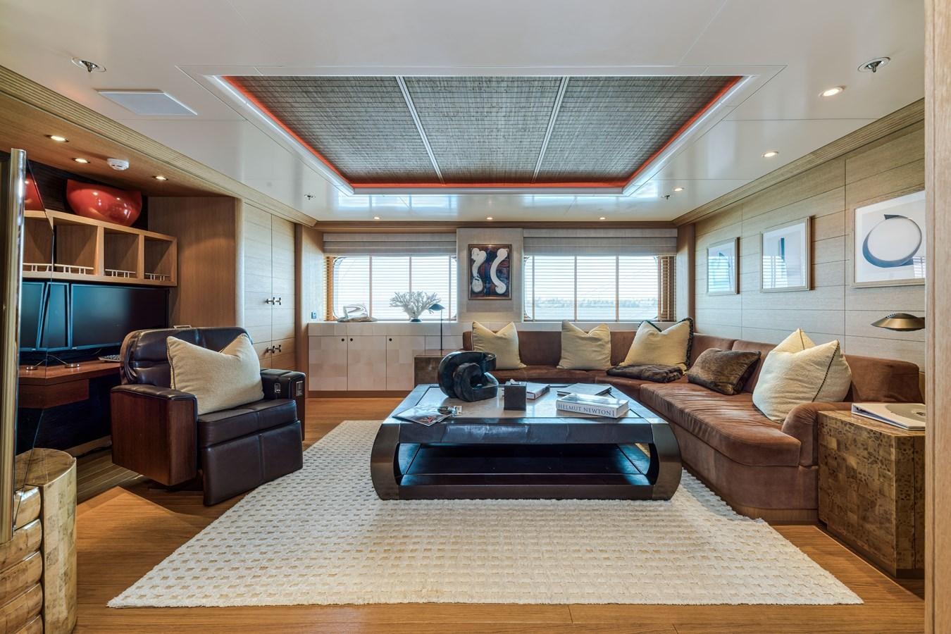 a living room with a large white rug and a large white rug aboard KOGO Yacht for Sale