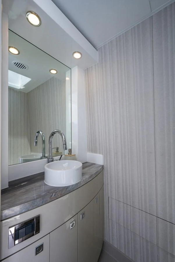 a bathroom with a sink and a mirror aboard G120 SIGNATURE SERIES Yacht for Sale