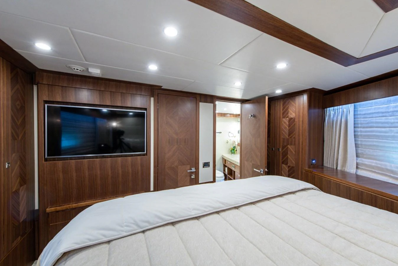 a bedroom with a bed and a television aboard G120 SIGNATURE SERIES Yacht for Sale