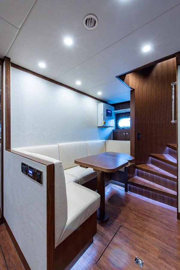 a room with a table and a bed aboard G120 SIGNATURE SERIES Yacht for Sale