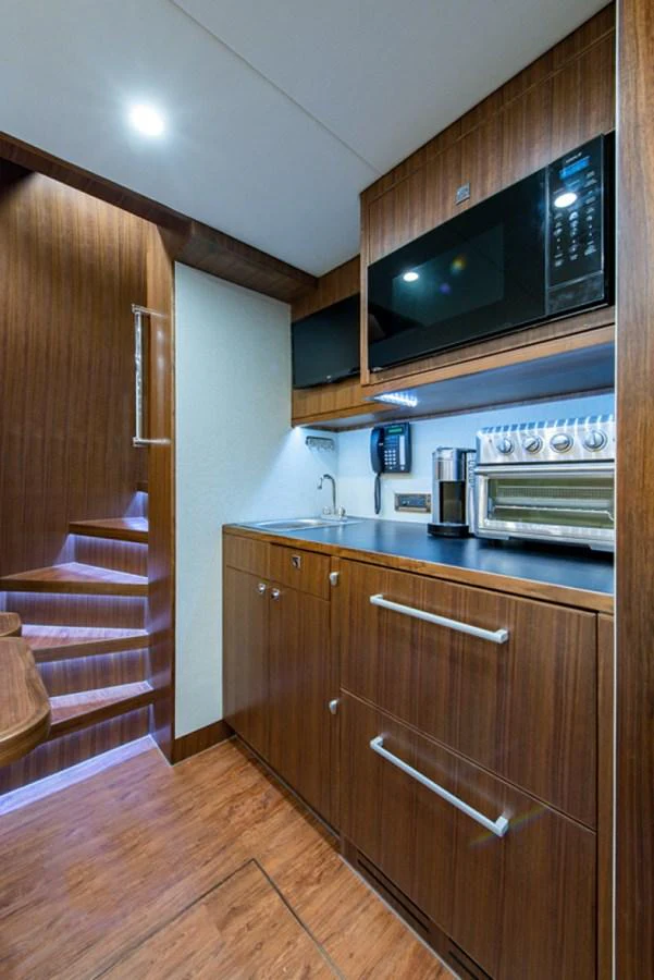 a kitchen with wooden cabinets aboard G120 SIGNATURE SERIES Yacht for Sale