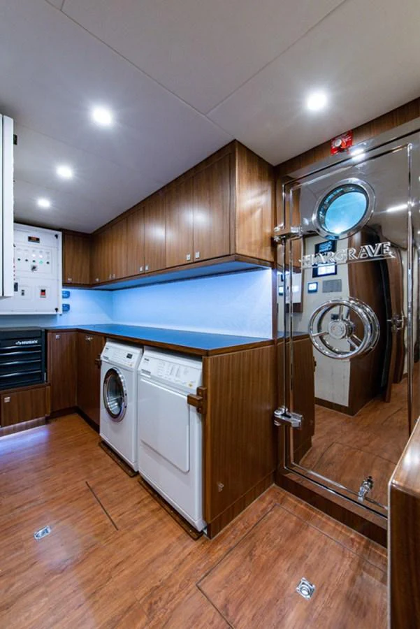 a kitchen with a washing machine and washer aboard G120 SIGNATURE SERIES Yacht for Sale