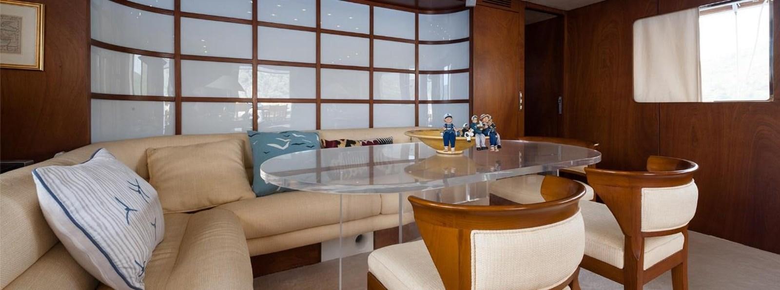 a room with a table and chairs aboard LADYAR B Yacht for Sale