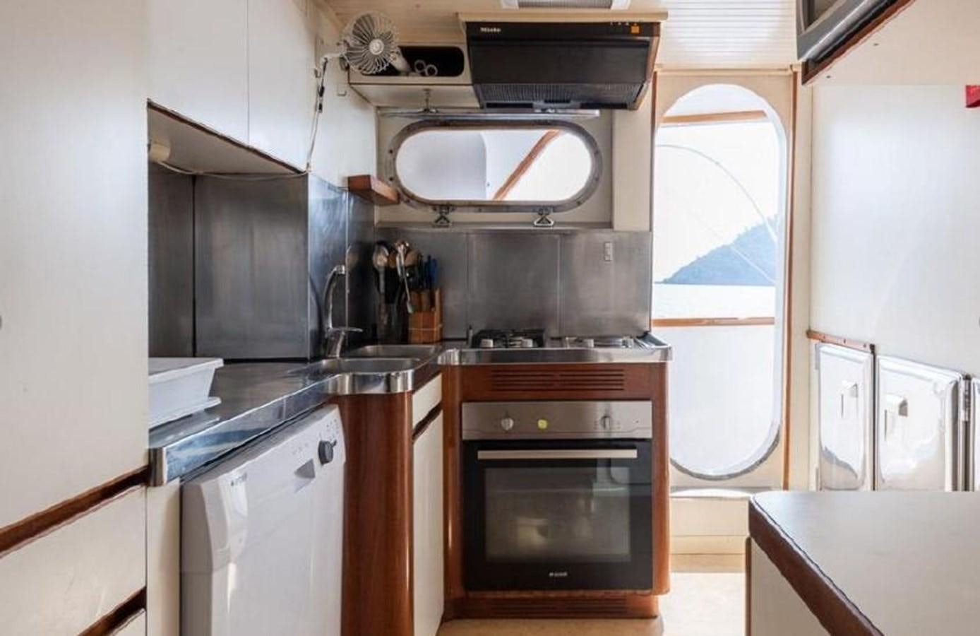 a kitchen with a stove and oven aboard LADYAR B Yacht for Sale
