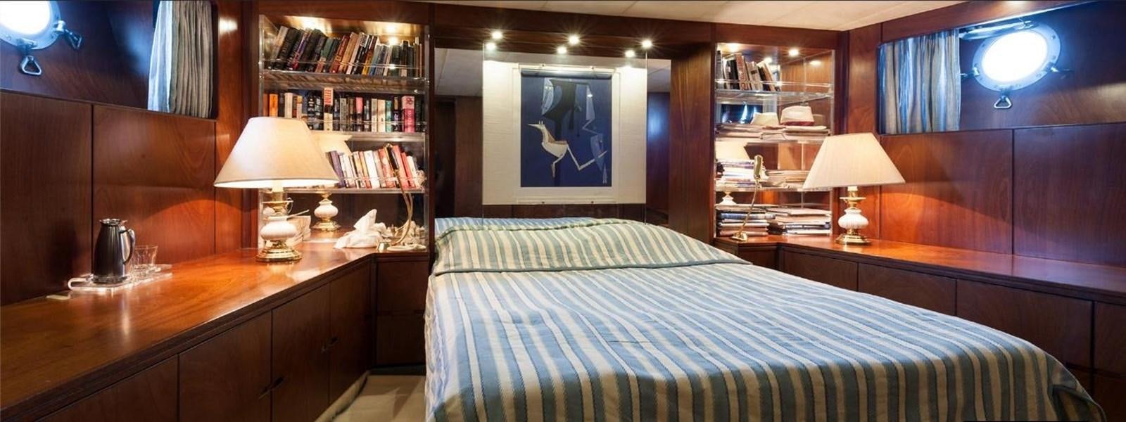 a bedroom with a bed and a desk aboard LADYAR B Yacht for Sale