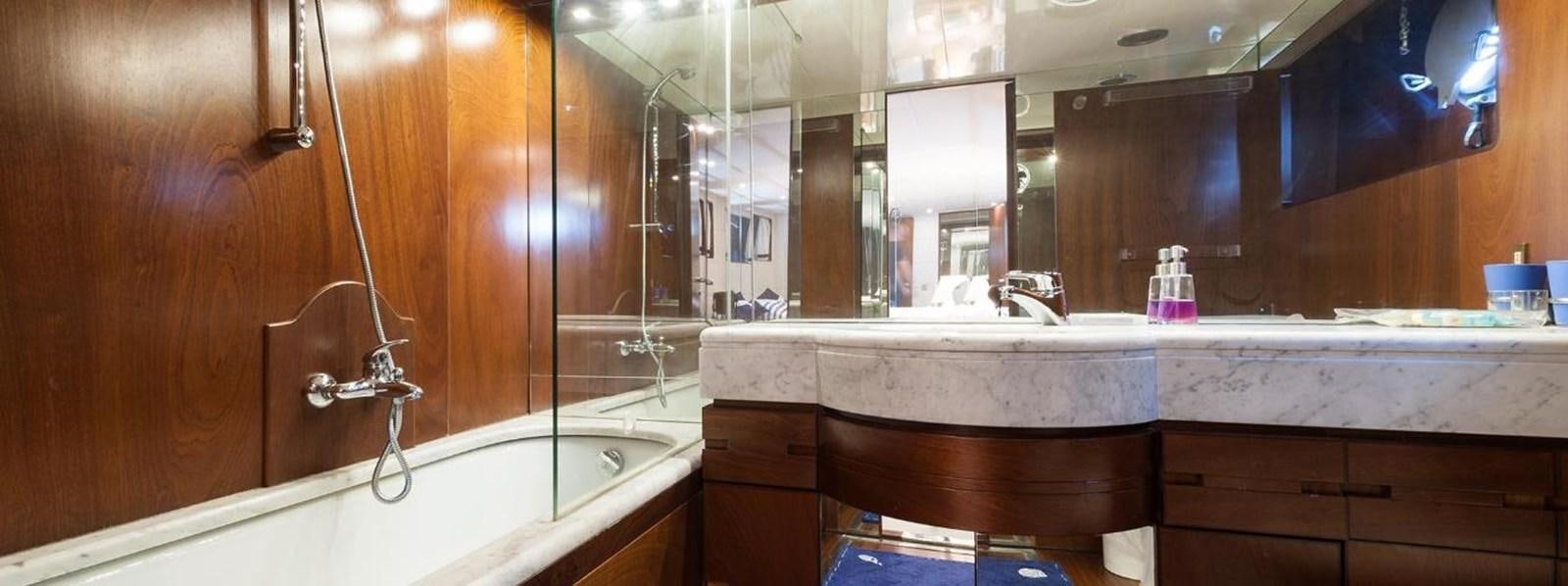 a bathroom with a bathtub and sinks aboard LADYAR B Yacht for Sale