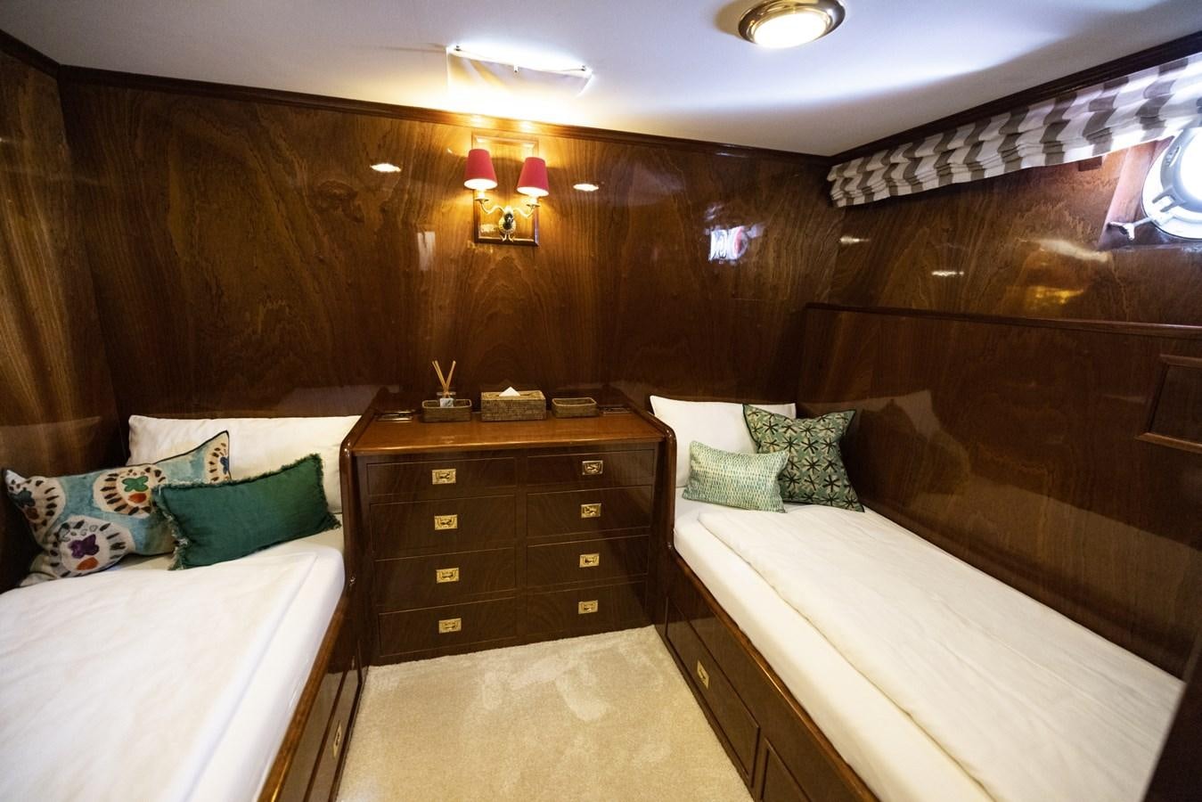 a room with a bed and a dresser aboard FRANCESCO PETRARCA Yacht for Sale