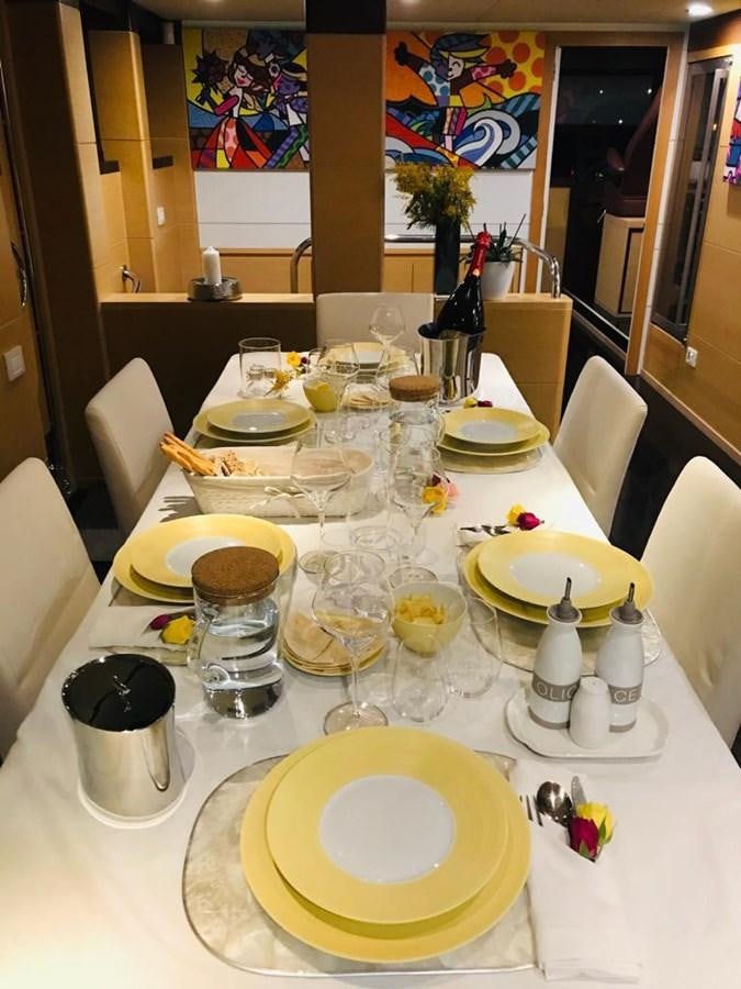 a table with plates and glasses aboard C. BOAT 27 SC Yacht for Sale