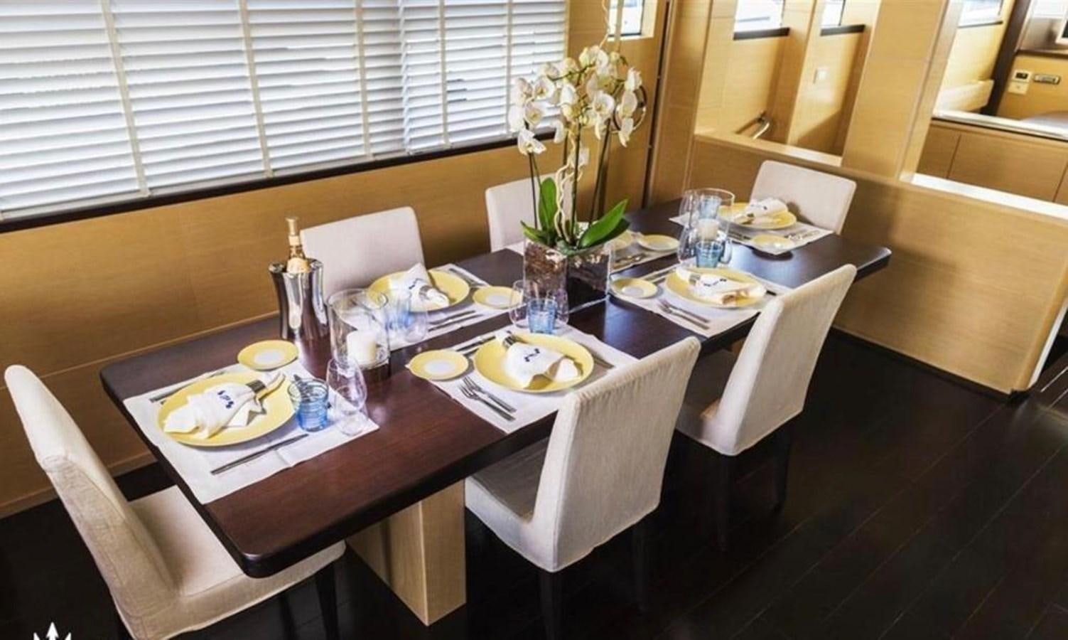 a table with plates and cups on it aboard C. BOAT 27 SC Yacht for Sale
