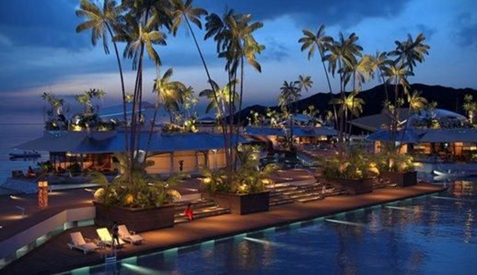 a pool with palm trees and a building in the background aboard 2020 ORION ORSOS ISLAND Yacht for Sale