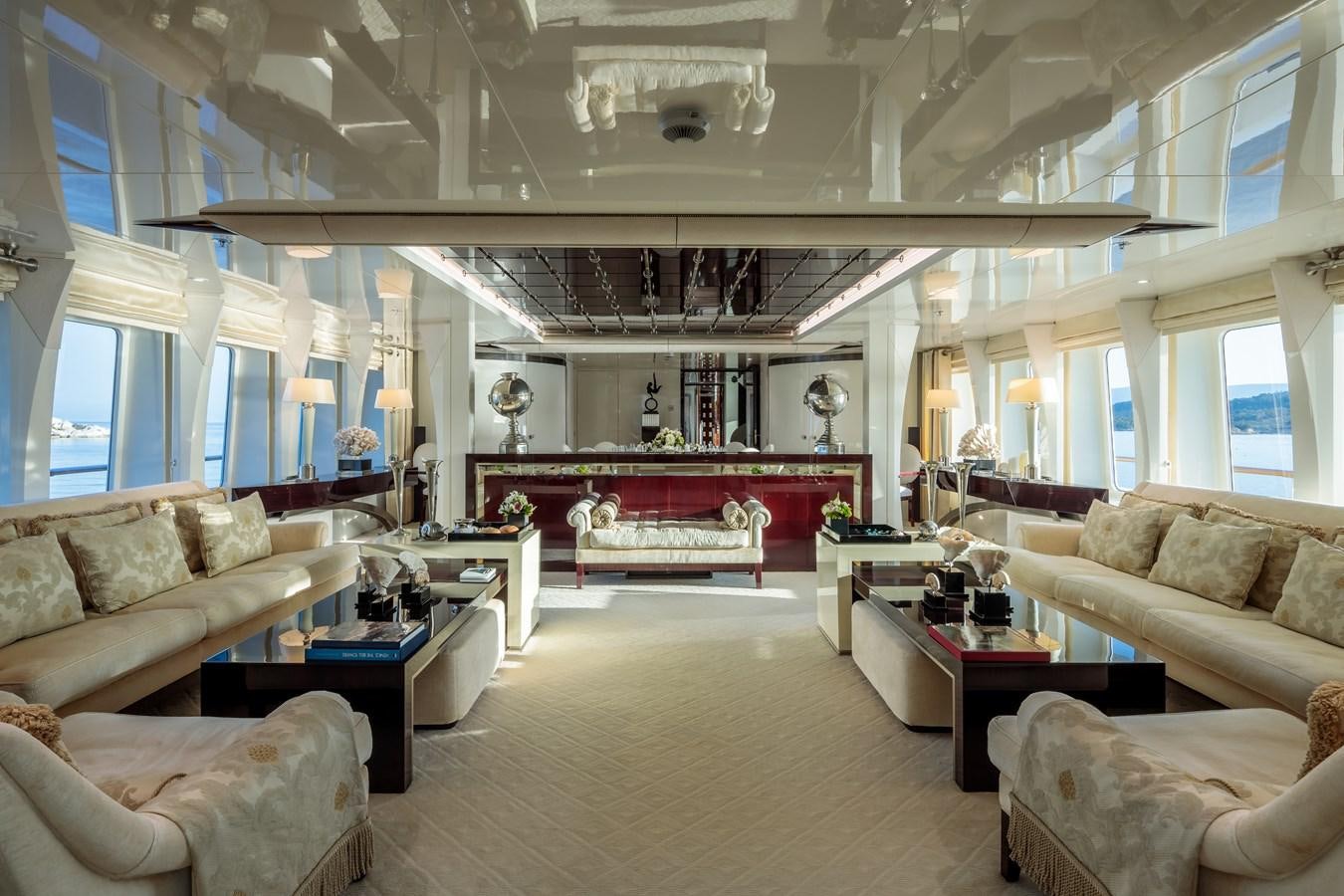 a living room with a large chandelier aboard VERA Yacht for Sale
