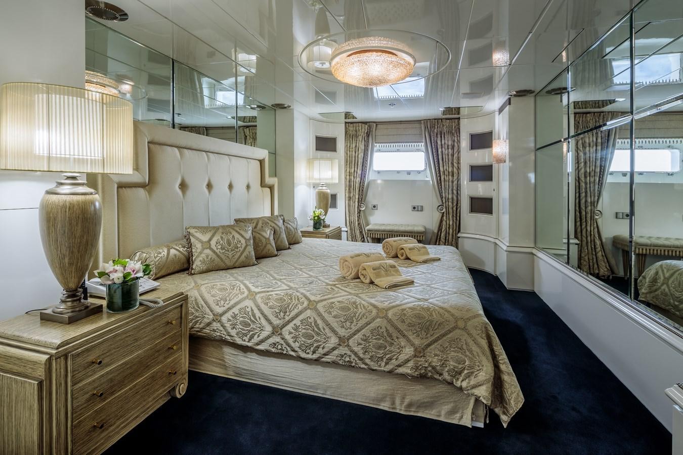 a large bedroom with a large bed aboard VERA Yacht for Sale