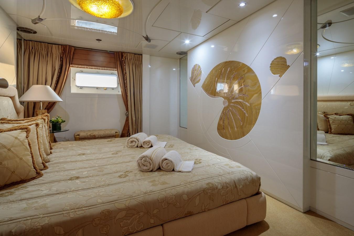 a bed with a large round mirror above it aboard VERA Yacht for Sale