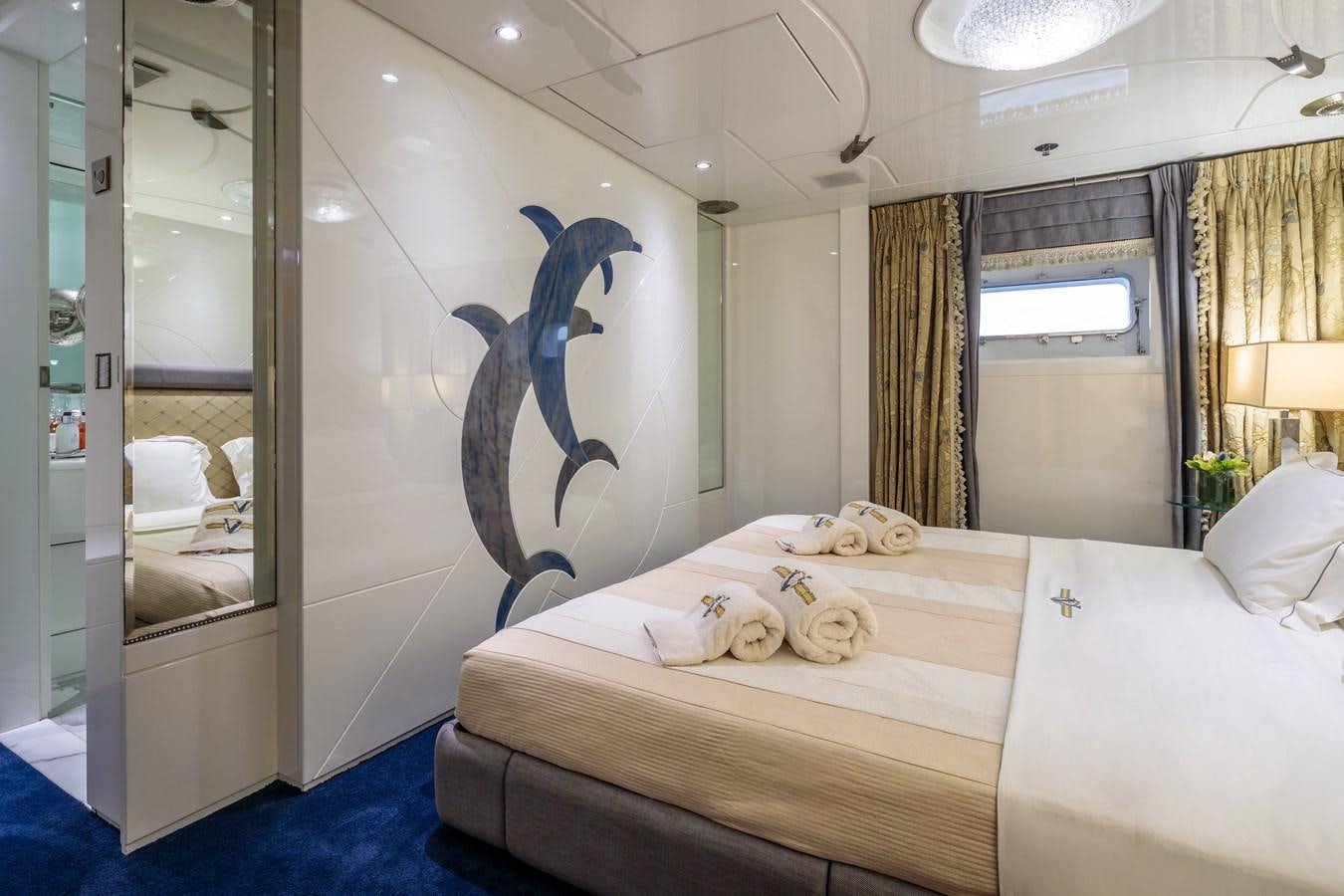 a bedroom with a bed and a mirror aboard VERA Yacht for Sale