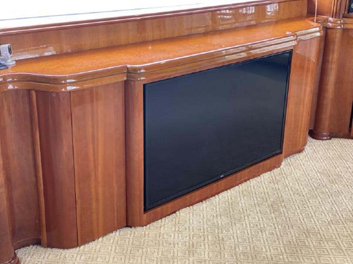 a wooden cabinet with a black screen aboard 85 AZIMUT ULTIMATE Yacht for Sale