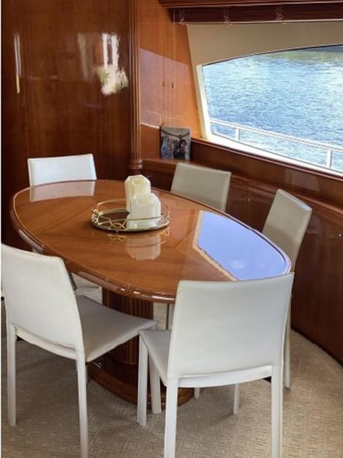 a table with chairs around it aboard 85 AZIMUT ULTIMATE Yacht for Sale