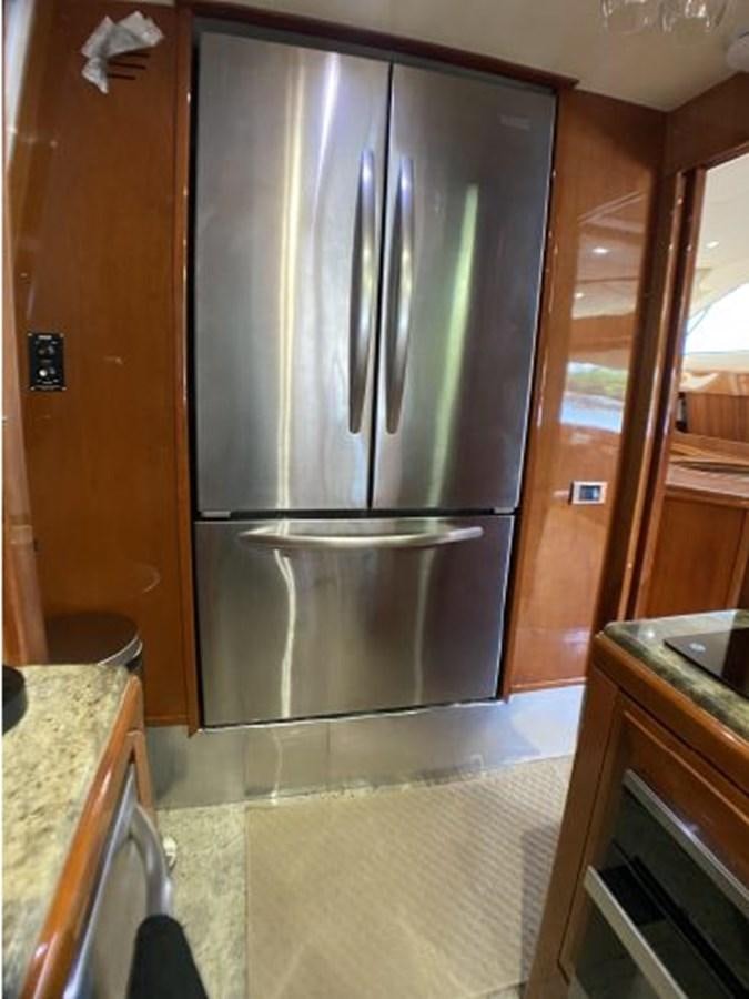 a stainless steel refrigerator in a kitchen aboard 85 AZIMUT ULTIMATE Yacht for Sale