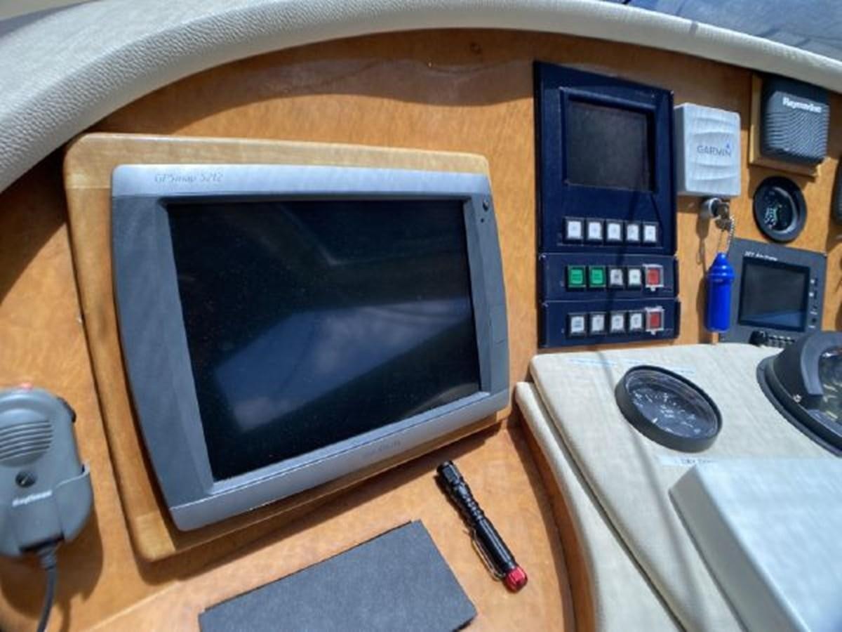 a computer monitor and a phone on a desk aboard 85 AZIMUT ULTIMATE Yacht for Sale