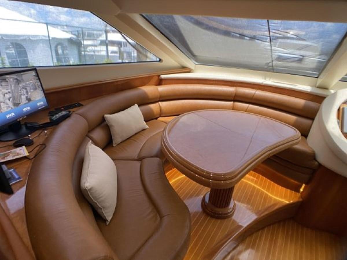 a couch and a table in a room aboard 85 AZIMUT ULTIMATE Yacht for Sale