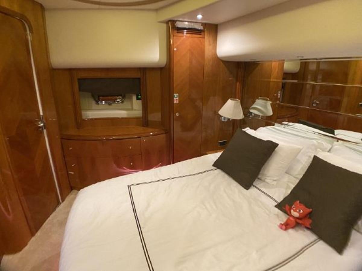a bed with a white sheet and a black bed with a red stuffed animal on it aboard 85 AZIMUT ULTIMATE Yacht for Sale