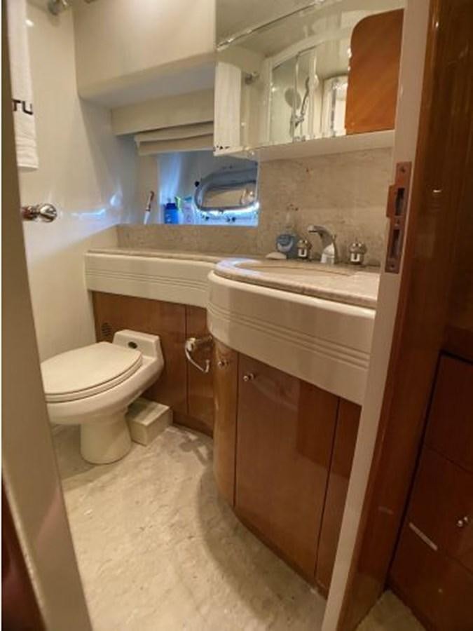 a bathroom with a sink toilet and a mirror aboard 85 AZIMUT ULTIMATE Yacht for Sale