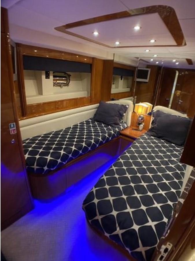 a bed with a blue comforter aboard 85 AZIMUT ULTIMATE Yacht for Sale