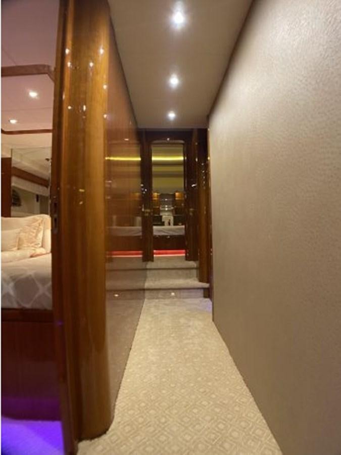 a hallway with a bed and a door aboard 85 AZIMUT ULTIMATE Yacht for Sale
