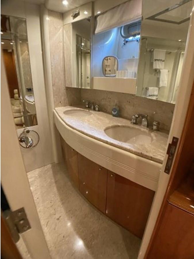 a bathroom with a sink and a mirror aboard 85 AZIMUT ULTIMATE Yacht for Sale