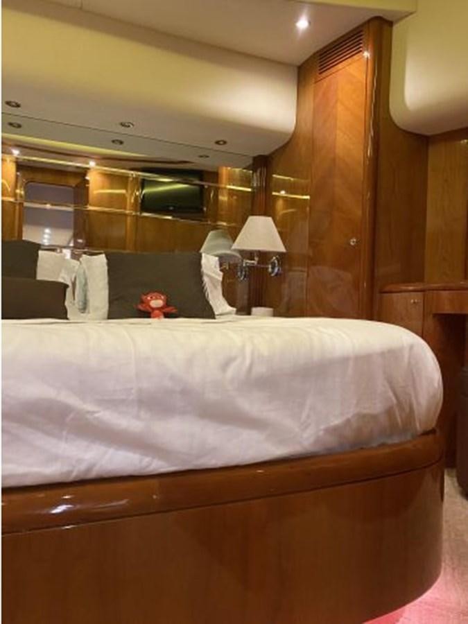 a bed with a white sheet and a brown bed spread aboard 85 AZIMUT ULTIMATE Yacht for Sale