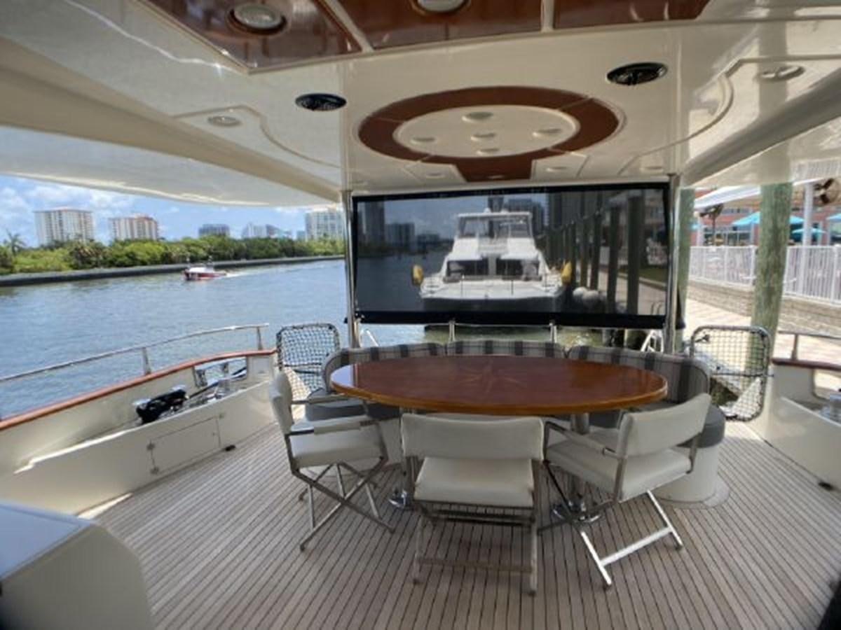 a table and chairs on a deck aboard 85 AZIMUT ULTIMATE Yacht for Sale