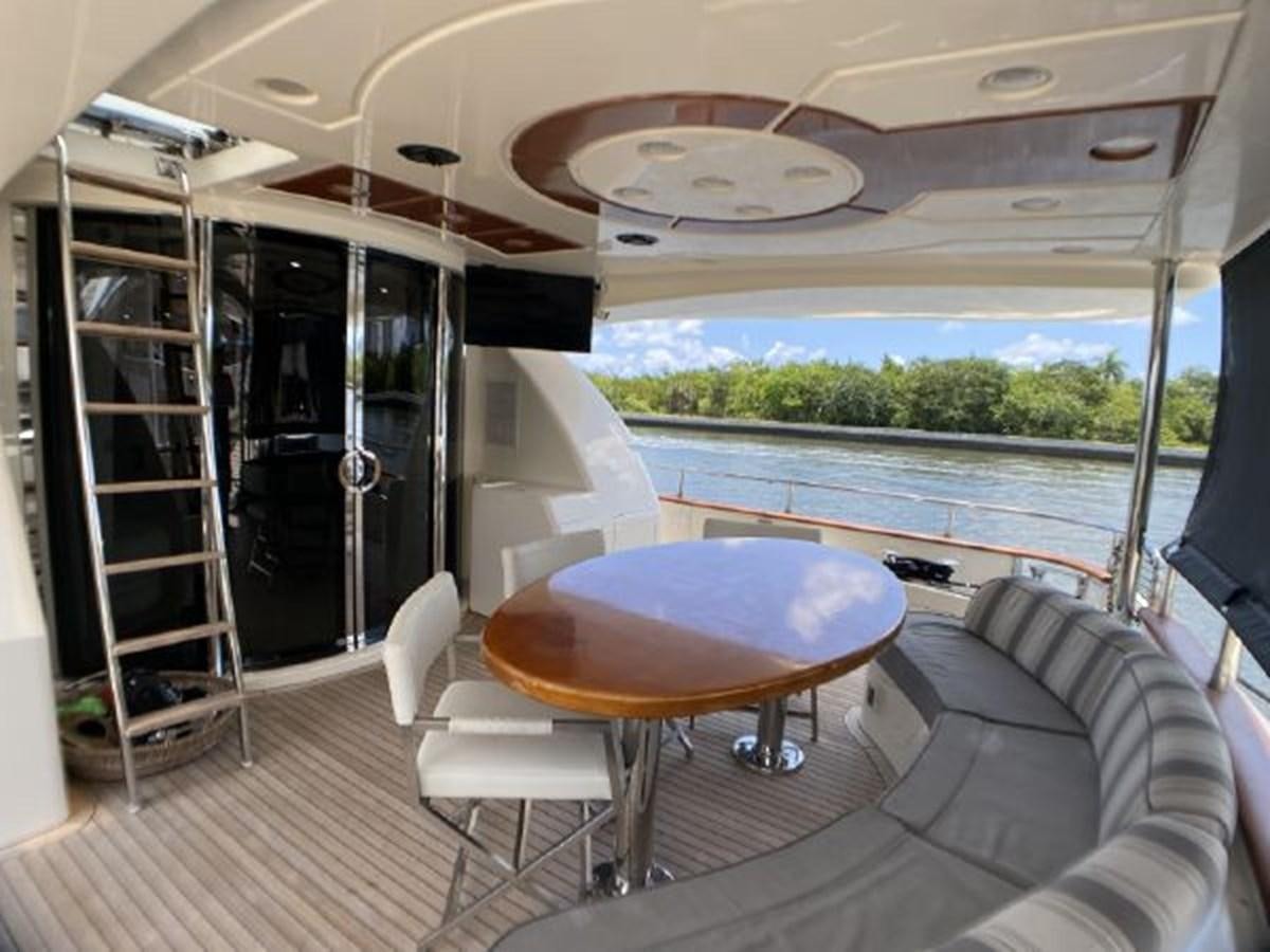 a boat with a table and chairs aboard 85 AZIMUT ULTIMATE Yacht for Sale